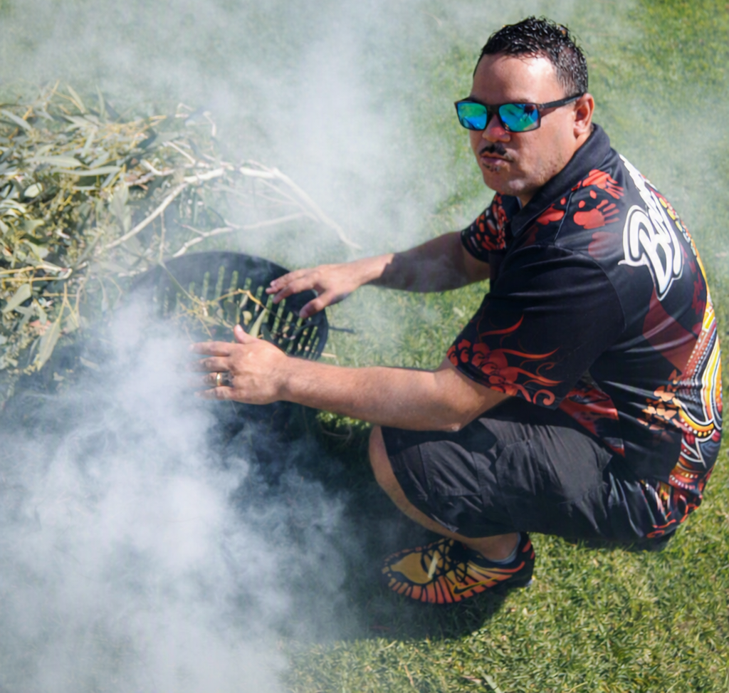 Smoking ceremony — lighting green gum leaves in a firepit for cleansing